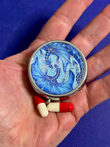 cute little round pill box featuring blue dragons intertwined in love. perfect get well gift. great present for lovers of the magical, mythical, mystical and fantasy. dragon lovers gift.