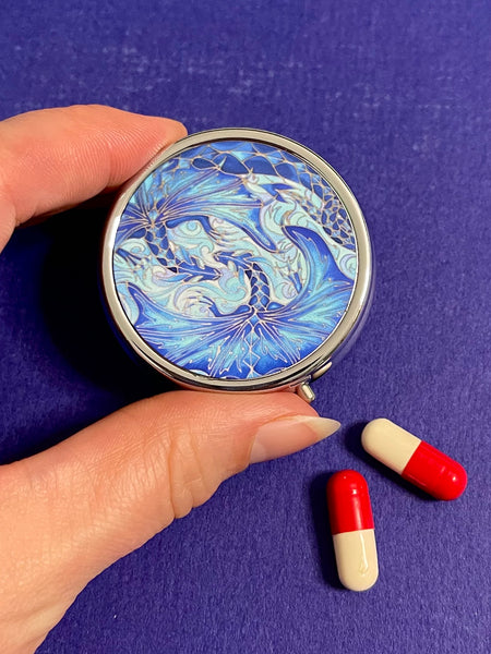 cute little round pill box featuring blue dragons intertwined in love. perfect get well gift. great present for lovers of the magical, mythical, mystical and fantasy. dragon lovers gift.