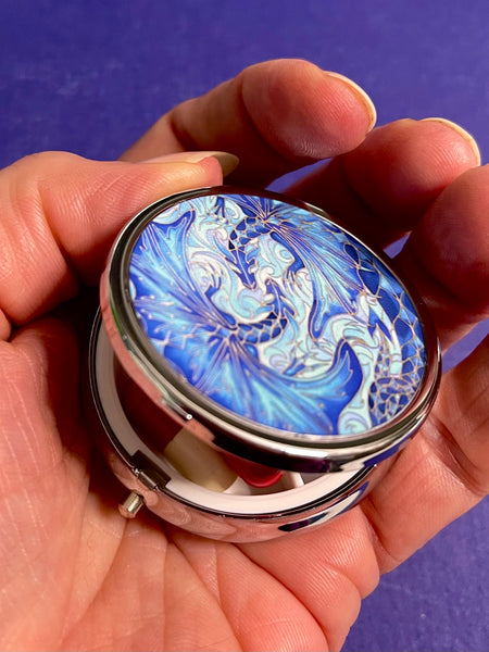 cute little round pill box featuring blue dragons intertwined in love. perfect get well gift. great present for lovers of the magical, mythical, mystical and fantasy. dragon lovers gift.