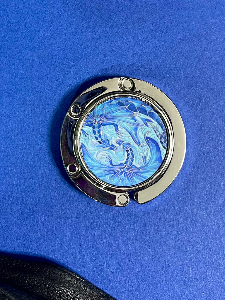 Blue dragon business hand bag hanger, keep in your handbag, unfurl hook to hang you hand bag form cafe or restaurant table. Keeps bag of the dirty floor and safe in your line of vision.