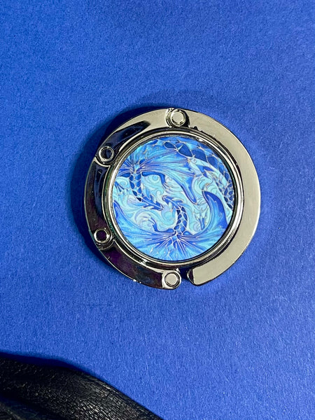 Blue dragon business hand bag hanger, keep in your handbag, unfurl hook to hang you hand bag form cafe or restaurant table. Keeps bag of the dirty floor and safe in your line of vision.